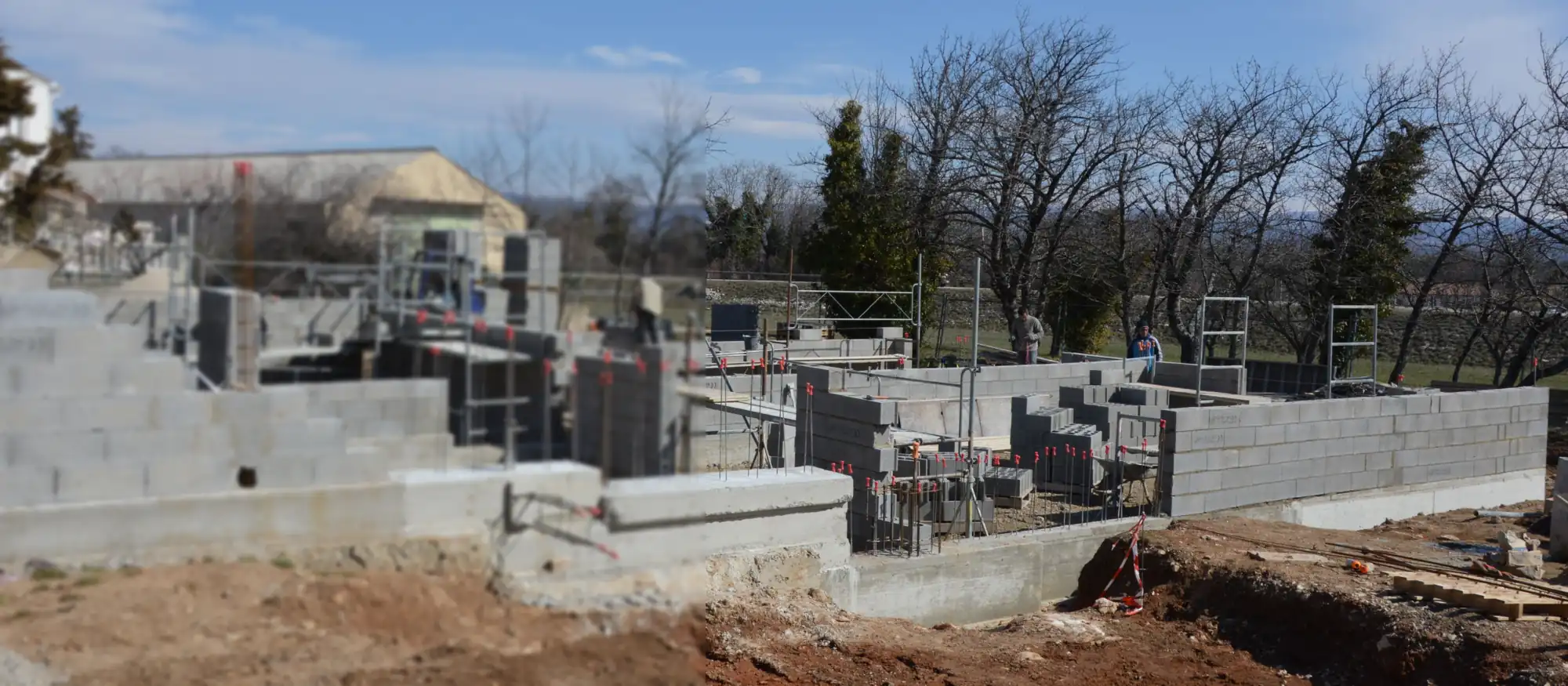 Concrete block walls of a new building shell rising on a construction site