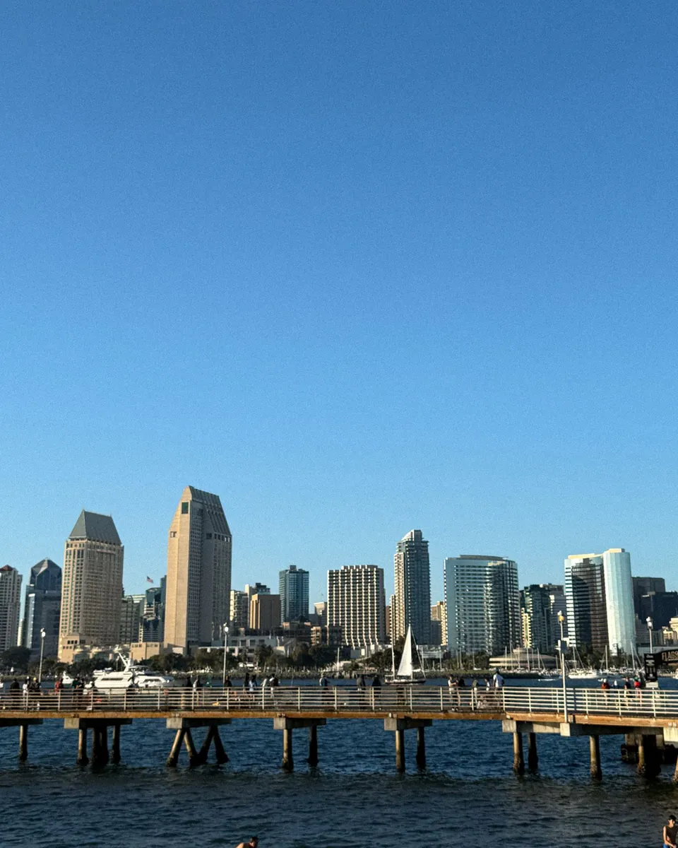 Downtown San Diego, CA skyline across the bay from a waterfront pier