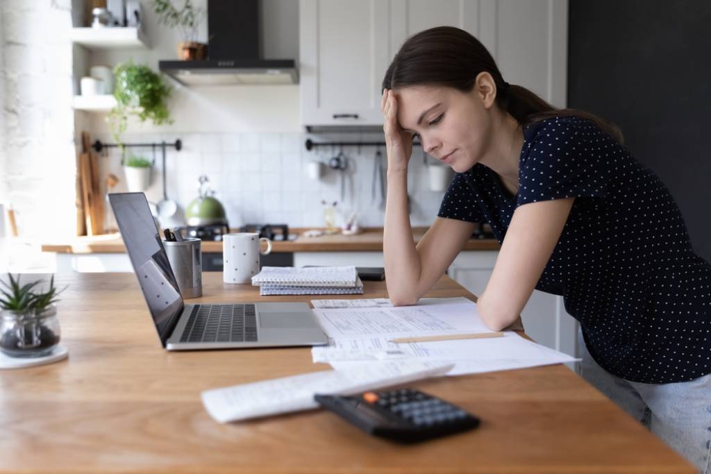 Concerned young woman looking at her tax bill.